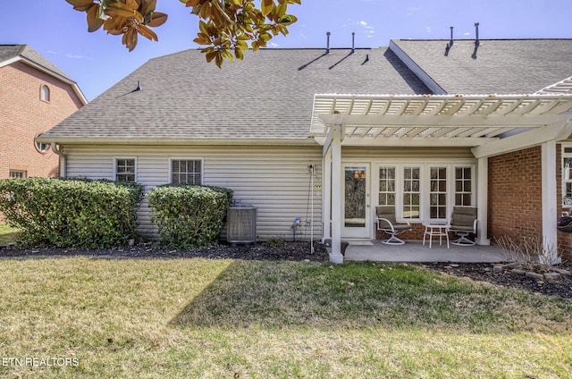 rear view of house with a shingled roof, a lawn, a patio area, a pergola, and cooling unit