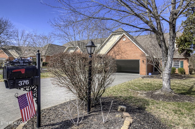 view of home's exterior featuring driveway, brick siding, and an attached garage