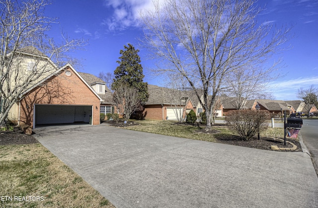 view of front facade featuring concrete driveway, brick siding, and an attached garage