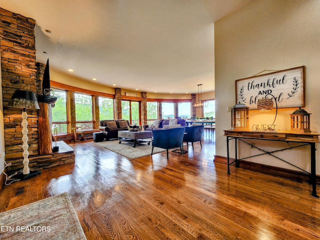 living room with recessed lighting, visible vents, and wood finished floors