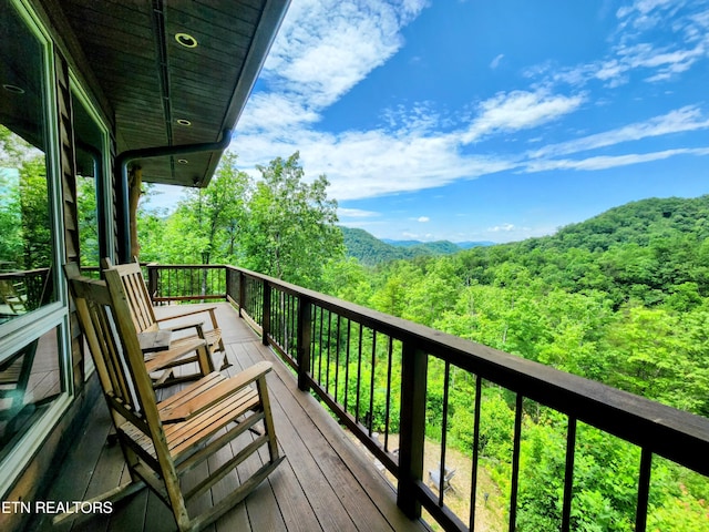 deck featuring a forest view