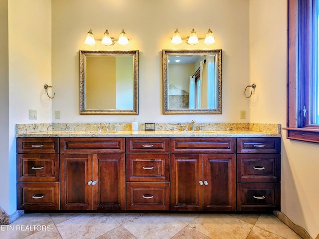 bathroom featuring a sink and double vanity