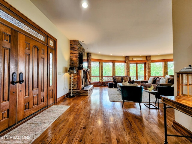 entryway featuring a healthy amount of sunlight, baseboards, wood finished floors, and recessed lighting