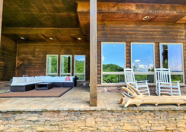 exterior space with wooden ceiling and beam ceiling