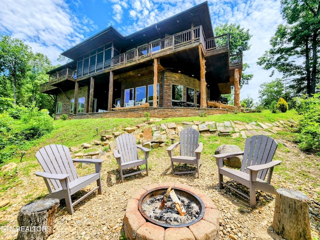 back of property with an outdoor fire pit