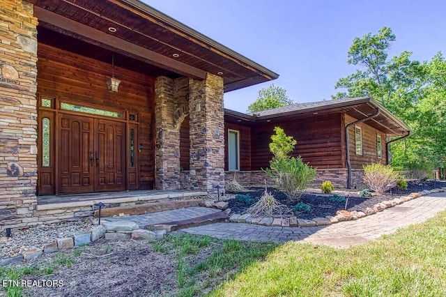 view of exterior entry featuring stone siding