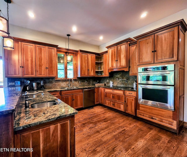 kitchen with brown cabinets, dark wood finished floors, open shelves, stainless steel appliances, and a sink