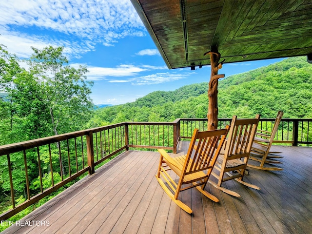 wooden deck with a forest view