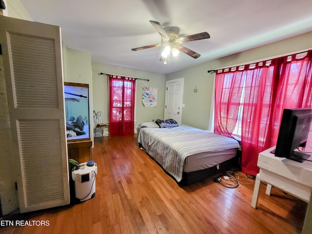 bedroom with wood finished floors and a ceiling fan