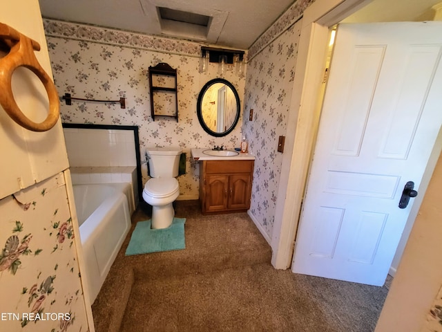 bathroom featuring toilet, wallpapered walls, a tub to relax in, and vanity