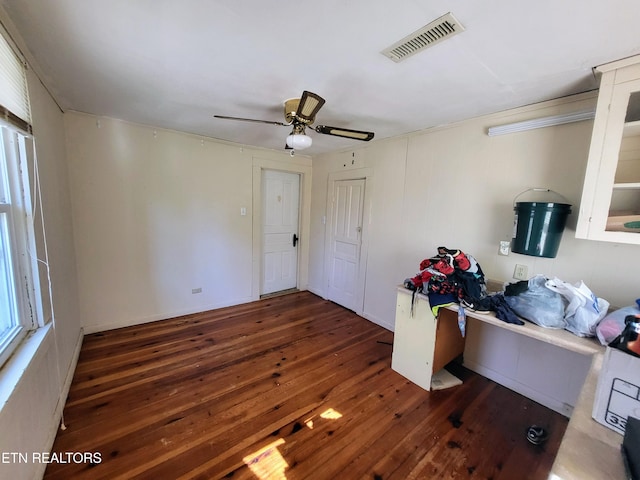 bedroom featuring hardwood / wood-style flooring, visible vents, and a ceiling fan