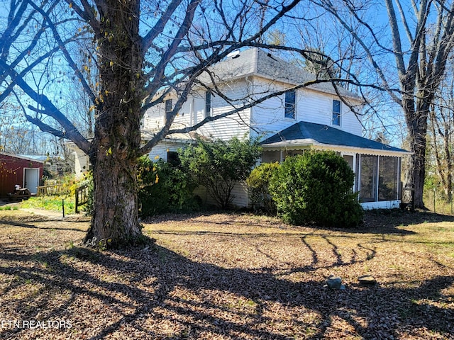 view of side of home with a sunroom