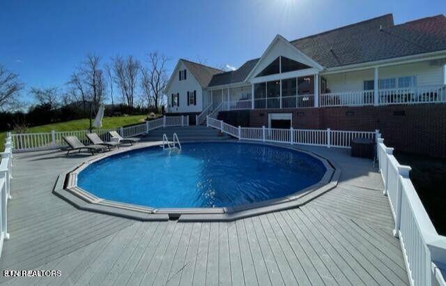 view of swimming pool with fence, a fenced in pool, and a wooden deck