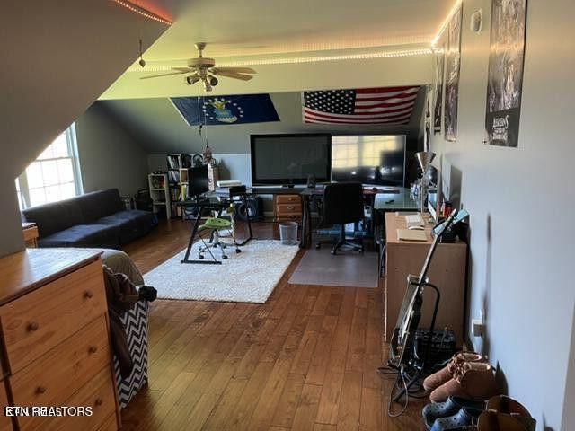 living area featuring hardwood / wood-style flooring and ceiling fan