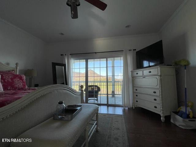 bedroom with access to exterior, dark wood-style flooring, ornamental molding, and ceiling fan