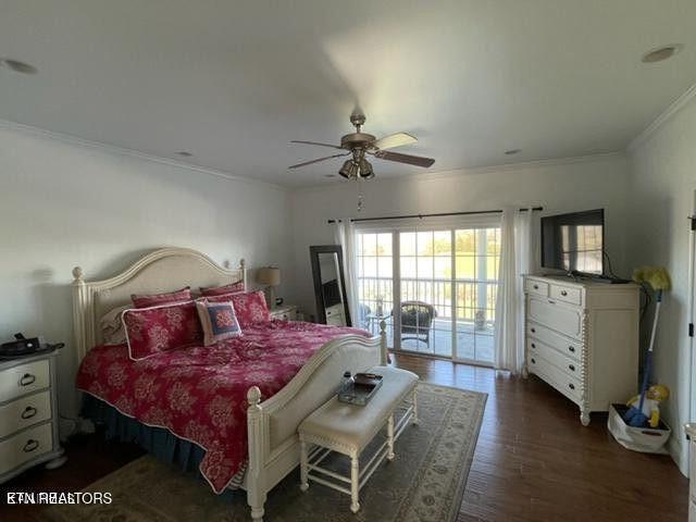 bedroom featuring dark wood-style floors, access to exterior, ornamental molding, and a ceiling fan