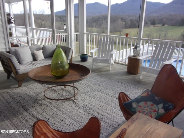 sunroom / solarium featuring a rural view and a mountain view