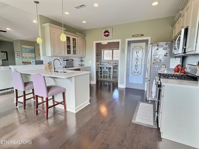 kitchen featuring stainless steel appliances, light countertops, visible vents, and decorative backsplash