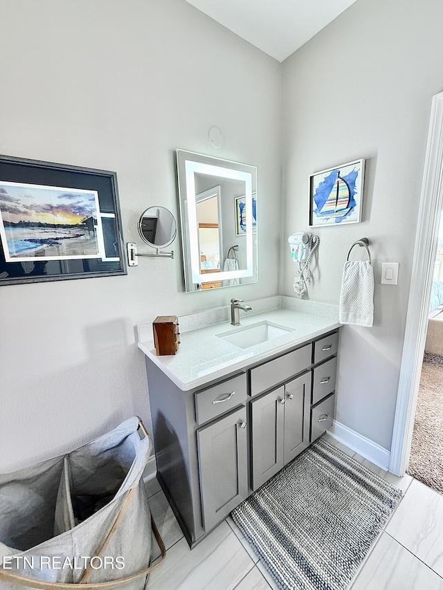 bathroom featuring vanity and baseboards