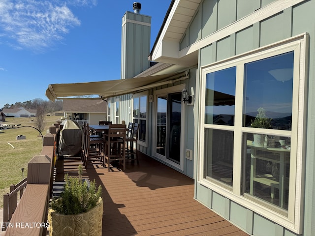 wooden terrace with outdoor dining area