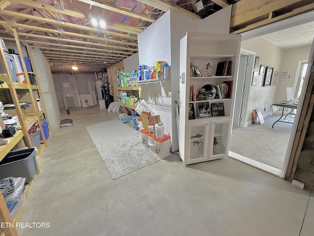 unfinished basement featuring water heater