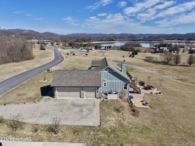 birds eye view of property featuring a water and mountain view