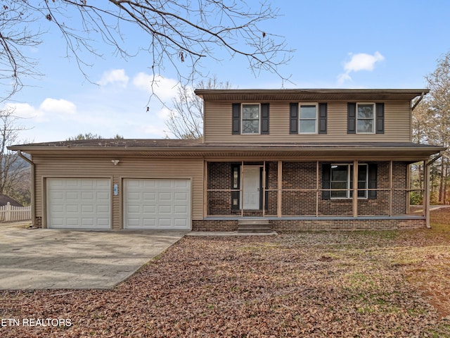 traditional-style home featuring a garage, covered porch, brick siding, and driveway