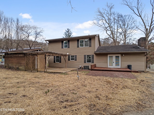 rear view of house featuring cooling unit, french doors, a pergola, a chimney, and a patio area