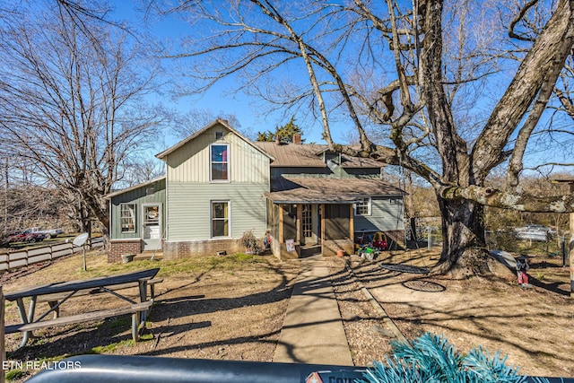 back of house featuring crawl space, a chimney, fence, and board and batten siding