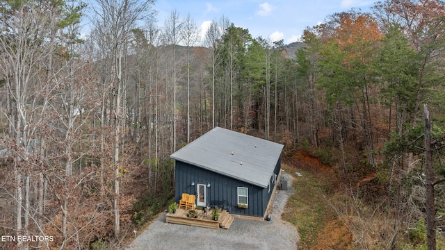 drone / aerial view featuring a forest view