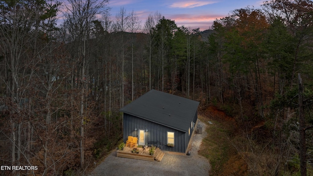 outdoor structure at dusk with a wooded view