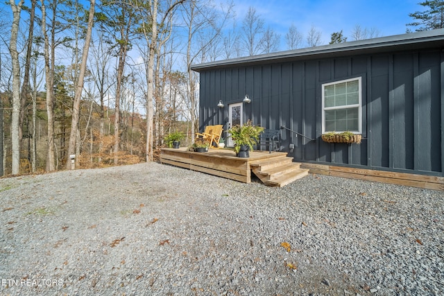 exterior space with board and batten siding and a wooden deck