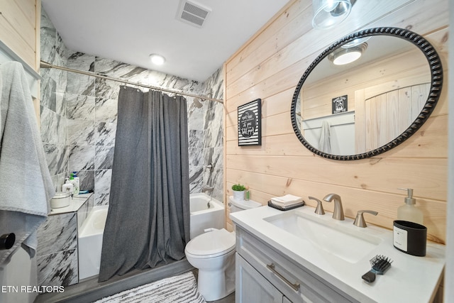 bathroom with toilet, wood walls, vanity, visible vents, and shower / tub combo with curtain