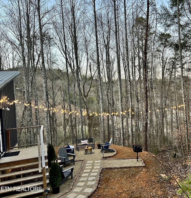 view of yard featuring a fire pit and a deck