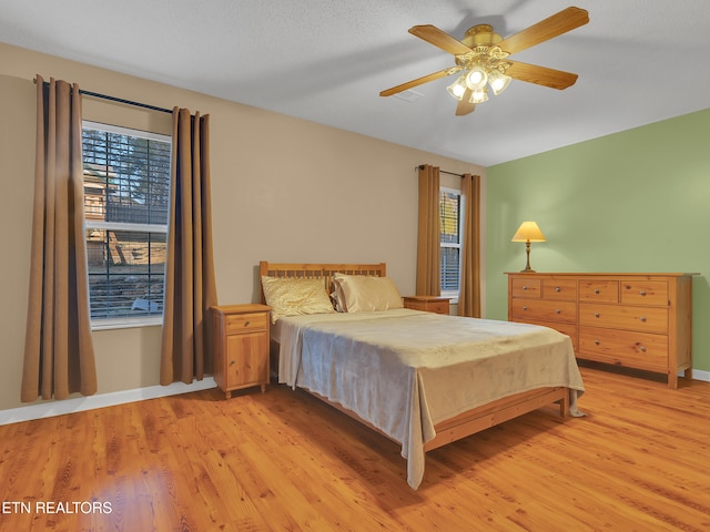 bedroom featuring light wood-type flooring and ceiling fan