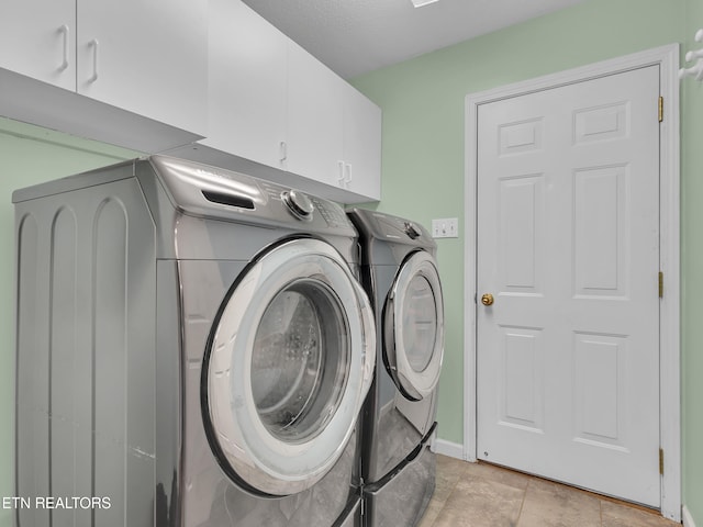 laundry room featuring washer and clothes dryer and cabinet space