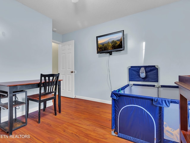 home office featuring wood finished floors and baseboards