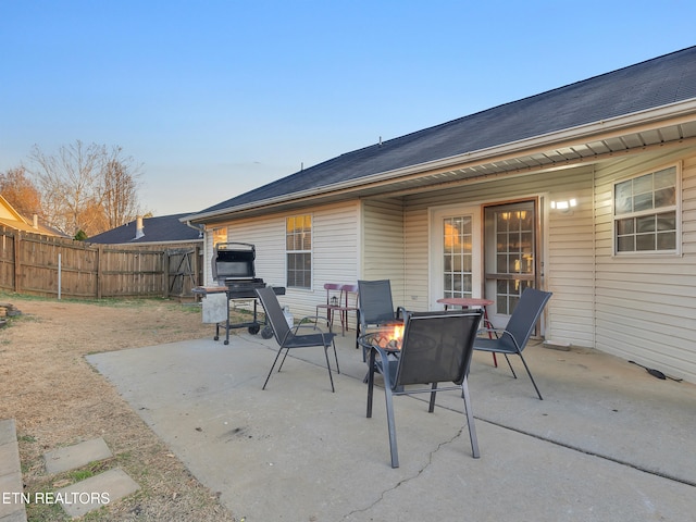 view of patio with an outdoor fire pit and fence