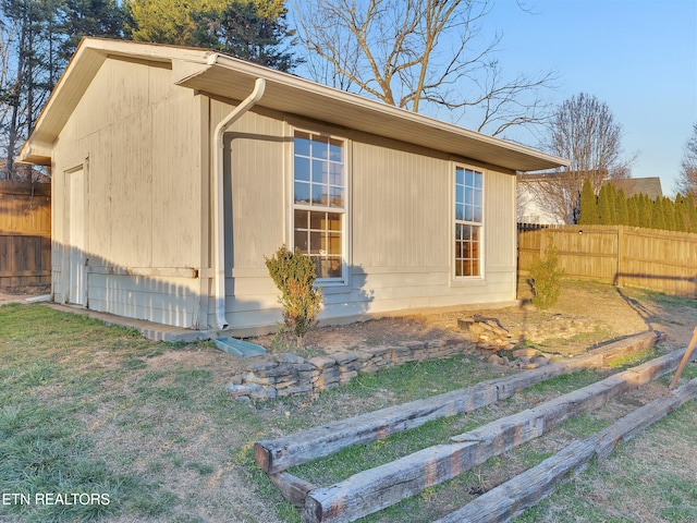 view of side of home with fence