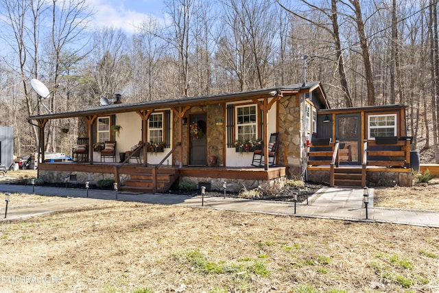 view of front of property featuring a porch and stone siding