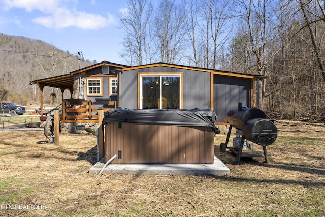 exterior space with a hot tub