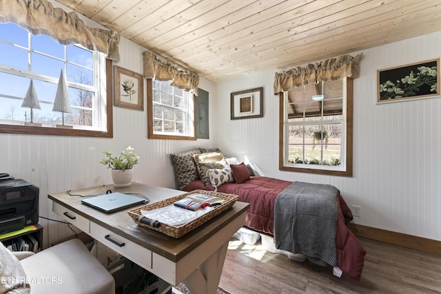 bedroom with multiple windows, wooden ceiling, and wood finished floors