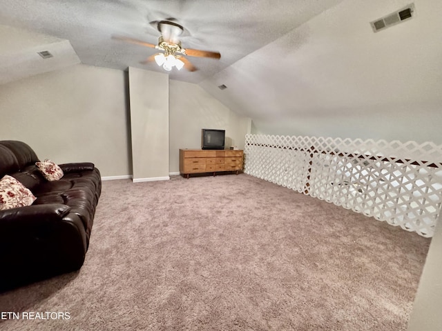 bonus room featuring lofted ceiling, a textured ceiling, visible vents, and carpet flooring