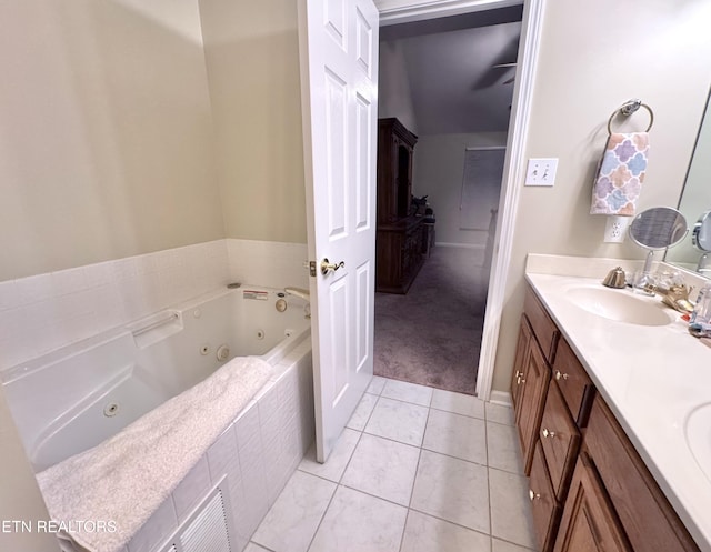 bathroom featuring double vanity, visible vents, a sink, a tub with jets, and tile patterned floors