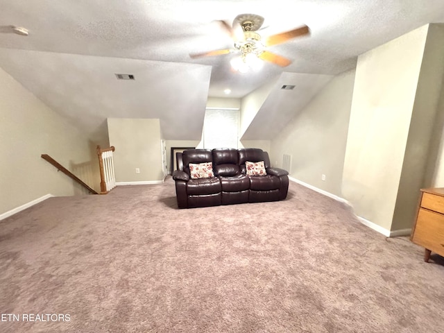 interior space featuring lofted ceiling, visible vents, a textured ceiling, and baseboards