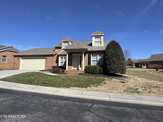 view of front of property with a garage, a front lawn, concrete driveway, and brick siding