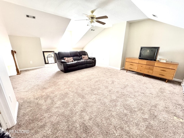 living area with carpet floors, visible vents, vaulted ceiling, and a ceiling fan