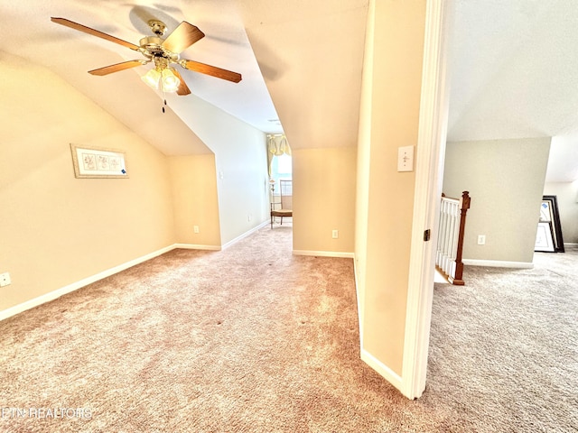 bonus room featuring a ceiling fan, light colored carpet, vaulted ceiling, and baseboards