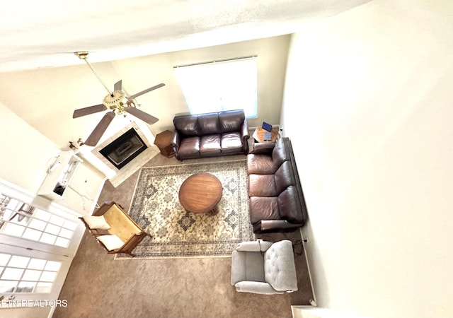 living room with a ceiling fan and carpet floors