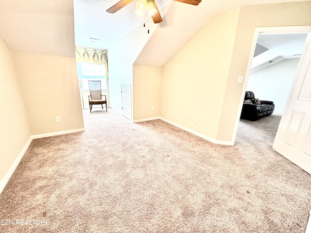 bonus room with ceiling fan, carpet, baseboards, and vaulted ceiling